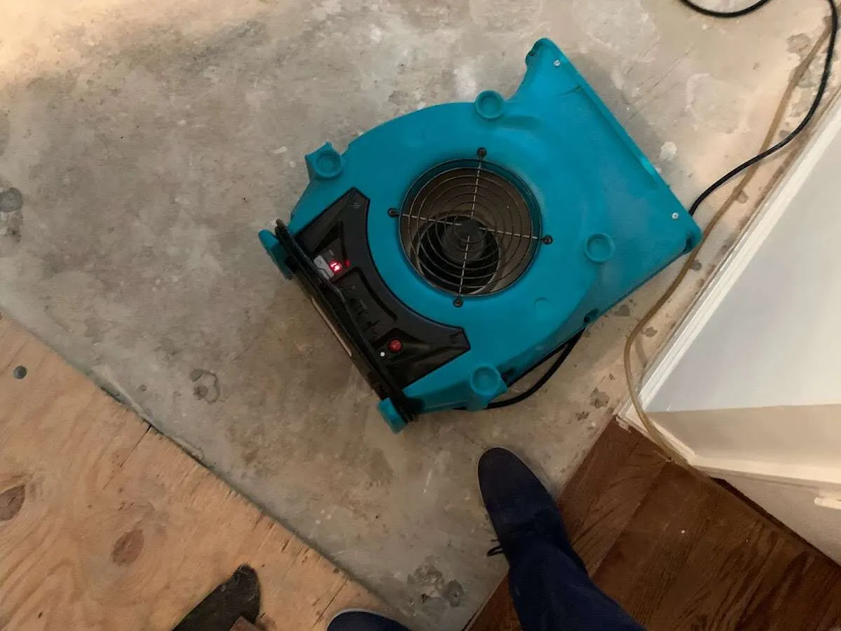 Air mover drying subfloor during Commercial Water Damage Restoration in Tallmadge